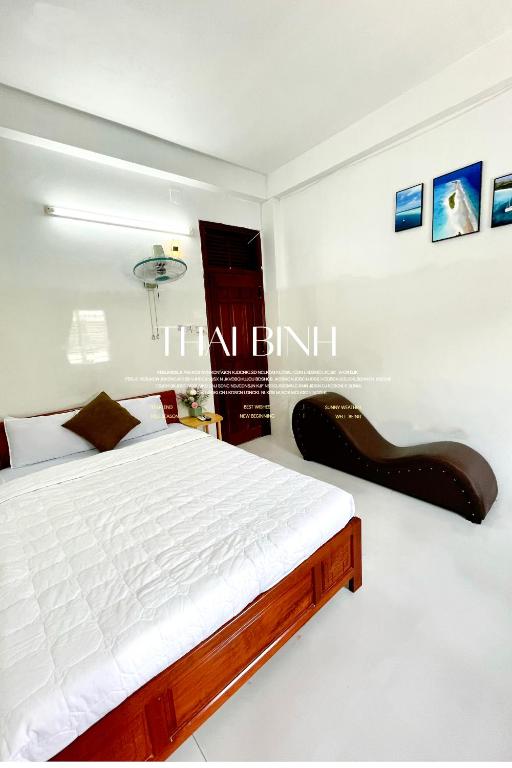 a bedroom with a bed and a pair of shoes at Thai Binh Motel in Danang