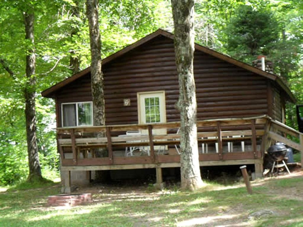 a log cabin in the middle of the woods at Secluded Lakeside Log Cabin Ideal for Couples Getaway' in Hayward, Wisconsin in New Post