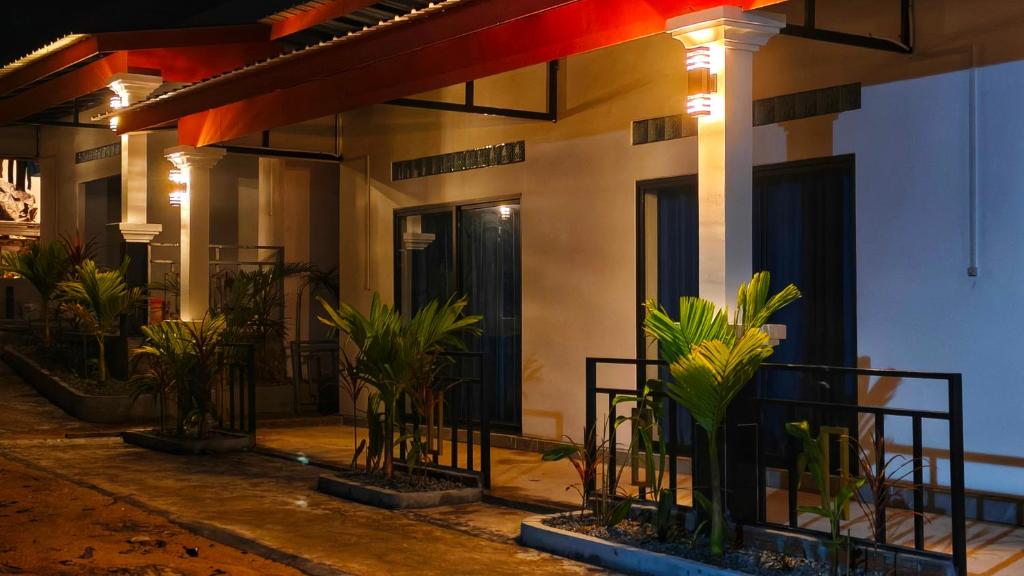 a building with a bunch of plants in front of it at David's Hostel & Restaurant in Koh Rong