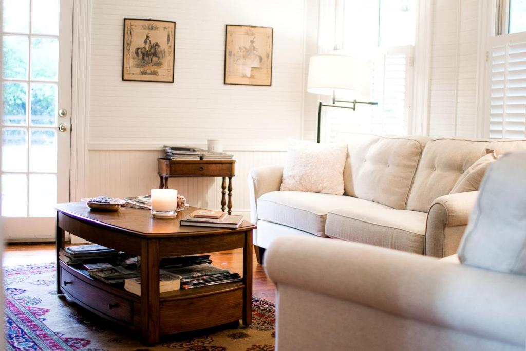 a living room with a couch and a coffee table at Historic Plantation House Suite with a Stone Fireplace in Ridge Spring, South Carolina in Ridge Spring