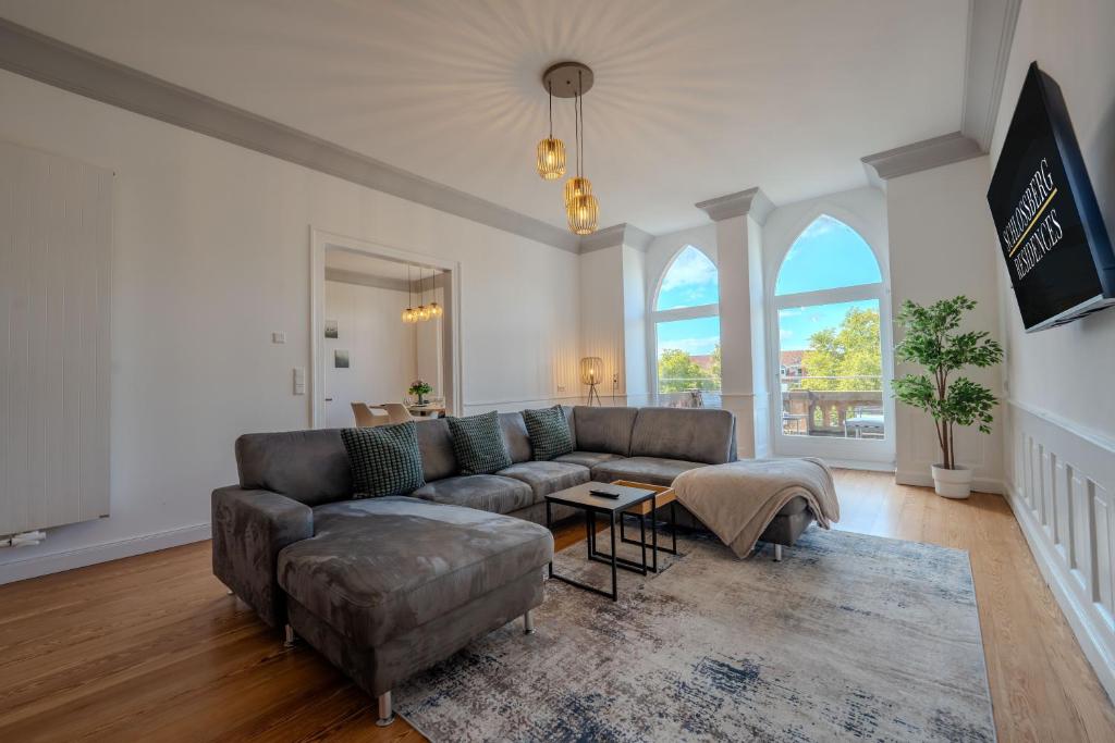 a living room with a couch and a table at SCHLOSSBERG RESIDENCES - Design City-Apartment im Herzen von Bensheim in Bensheim