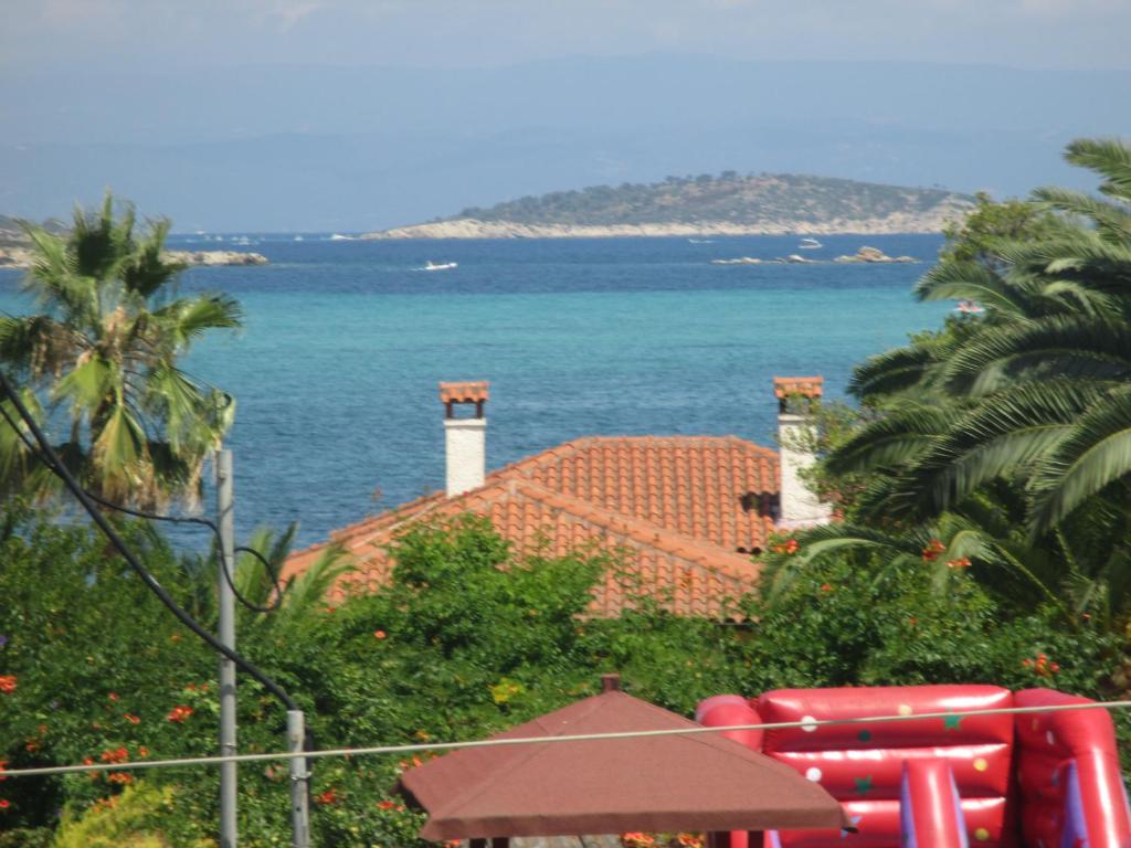 a view of the ocean from a resort at Maistros Holiday Home in Vourvourou