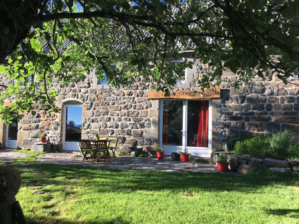 a stone building with a chair in front of it at Ciel d'Ardeche in Lachamp-Raphaël