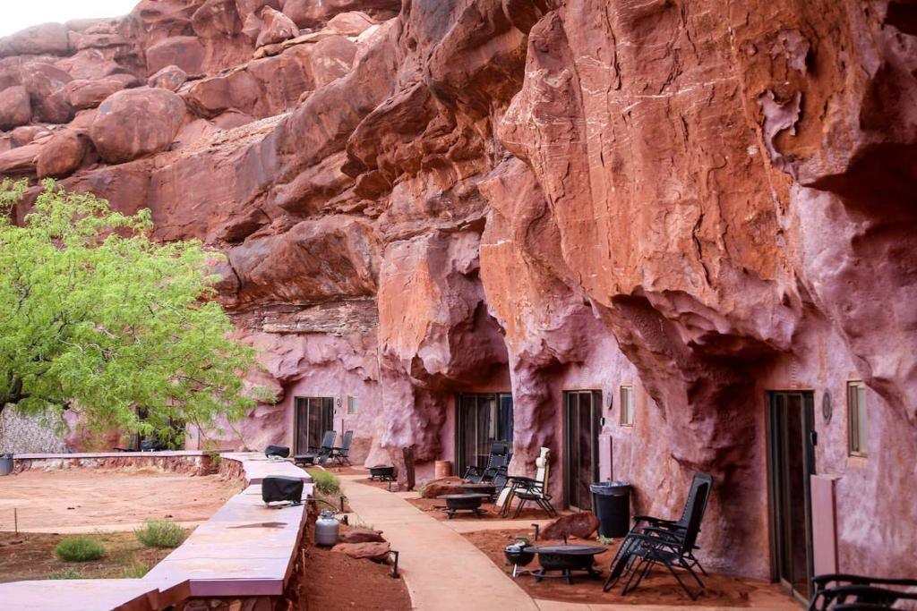 a group of benches in front of a mountain at Luxurious Cave for a Romantic Retreat near Arches National Park in Moab, Utah in Allen Memorial Hospital Heliport