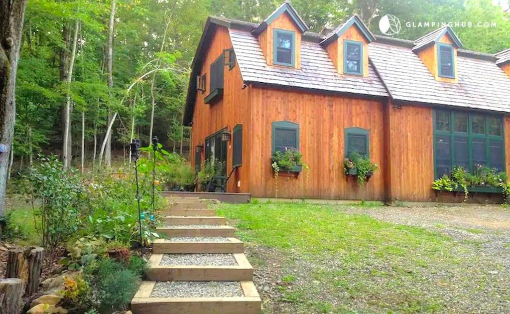 a wooden house with a pathway in front of it at Peaceful Getaway above a Beautiful Yoga Studio near Devil's Den Nature Preserve, Connecticut in Redding