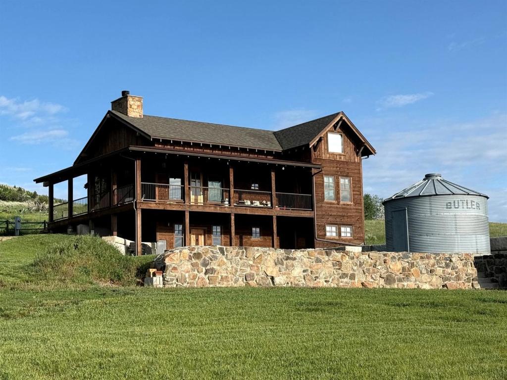 a large house with a silo in front of it at Charming Historic-Inspired Vacation Home with Mountain Views near Pony School House in Pony, Montana in Pony