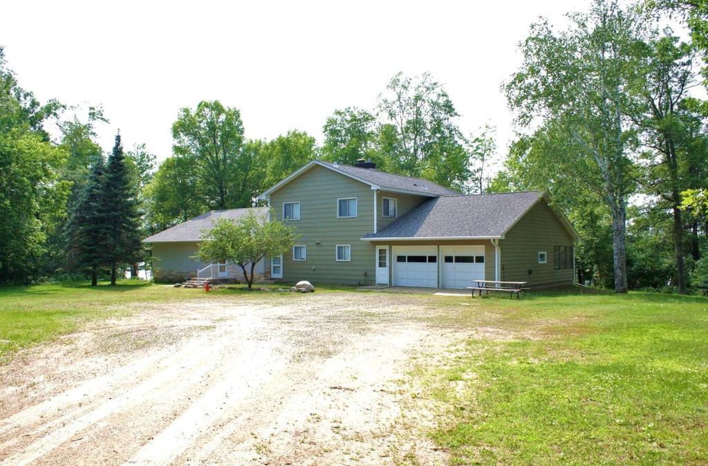 a house with a dirt road in front of it at Lakefront Cottage Rental with Game Room near Ruth Lake, Minnesota in Emily