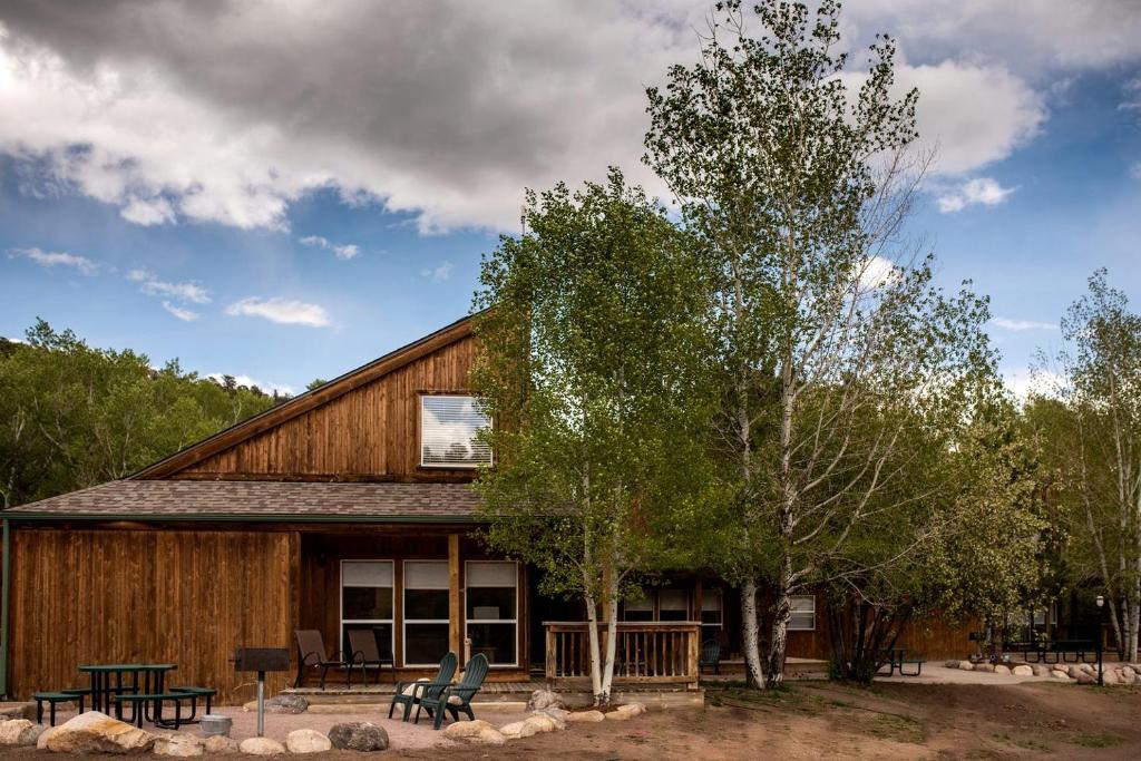 a large wooden cabin with benches in front of it at Eco-Friendly Cabin with Views of the Rocky Mountains in Colorado in Monarch