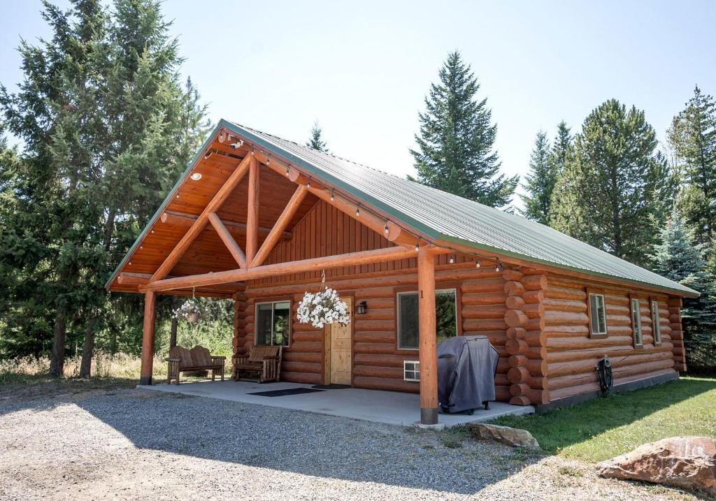 a log cabin with a porch and a patio at Spacious Pet-Friendly Log Cabin with King Bed & Full Kitchen | Bonners Ferry, Idaho Retreat in Bonners Ferry