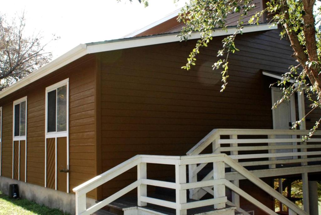 a house with a porch and a wooden ramp at Spacious Cabin Rental Overlooking the Guadalupe River near Austin, Texas in Fourth Crossing