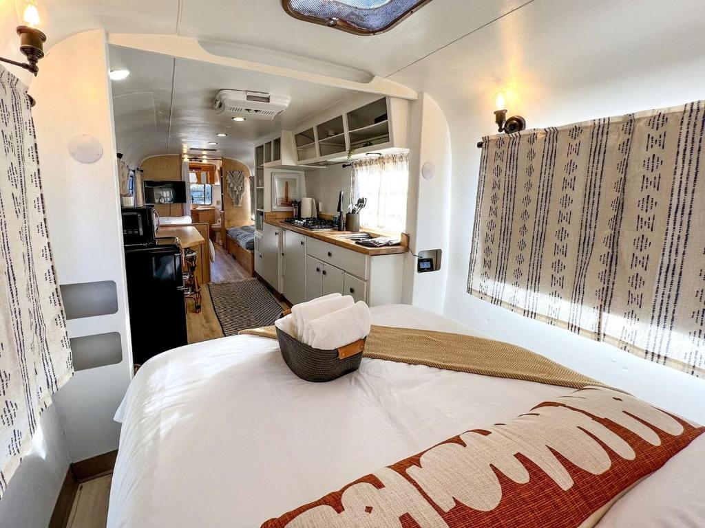a bedroom with a large bed in a kitchen at Luxe Pet-Friendly Airstream Retreat: Glamping Paradise in Grand Junction, Colorado in Grand Junction