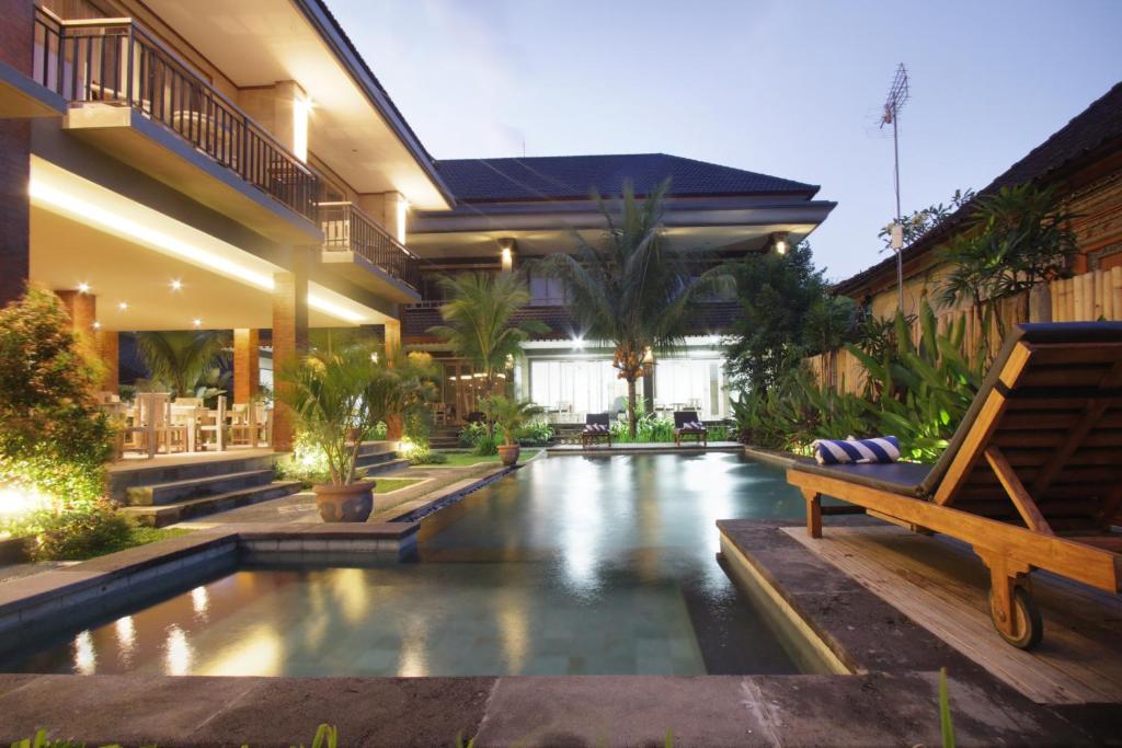 a house with a pool in the middle of a yard at Batu Empug Ubud by Mahaputra in Ubud