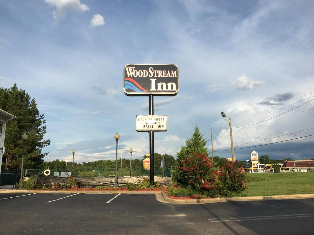 a sign for a woodham inn in a parking lot at Woodstream Inn in Hogansville