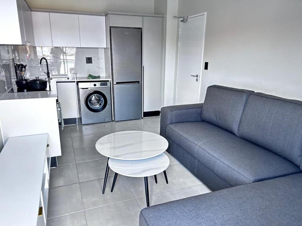 sala de estar con sofá y mesa en la cocina en The Blyde Inn, en Pretoria