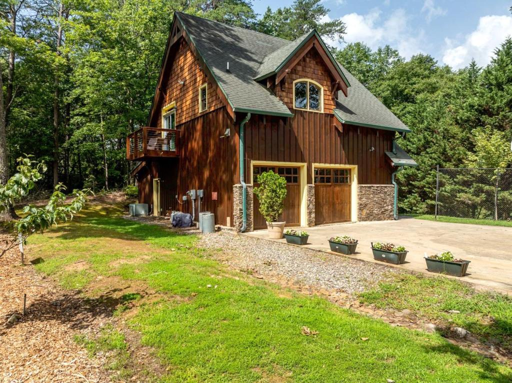 a large wooden barn with a porch at Delightful Cabin Rental with Mountain Views near Chattahoochee National Forest, Georgia in Mineral Bluff