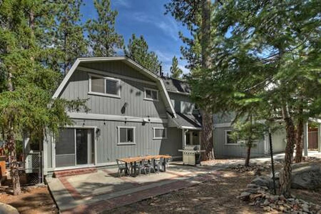 a house with a picnic table in front of it at Spacious Modern Cabin Near Big Bear Lake in California in Big Bear City