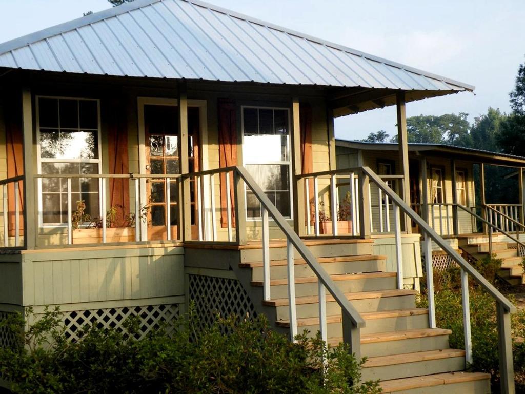 a house with stairs leading up to it at Expansive Vacation Lodge Rental for 60 Guests in Covington, Louisiana in Covington
