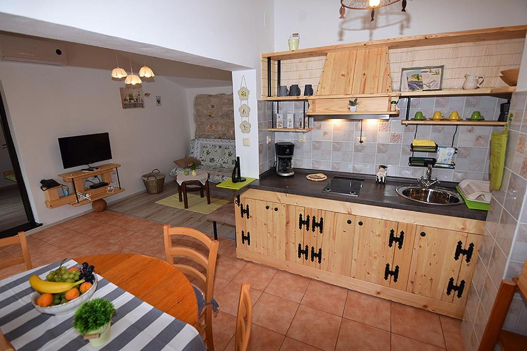 a kitchen with a table with a bowl of fruit on it at Apartment Nika in Šegotići
