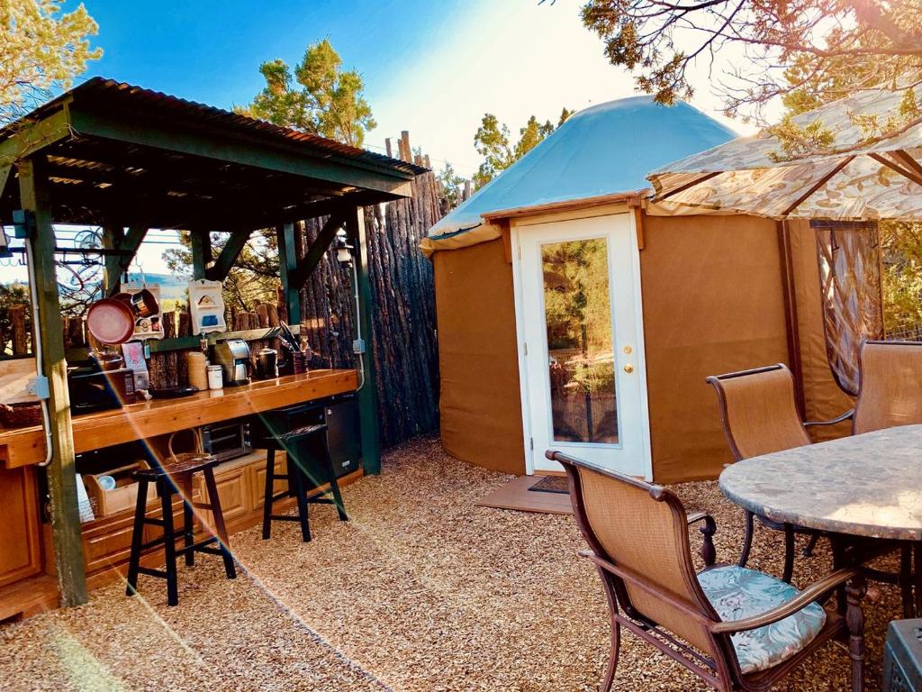 a gazebo with a table and chairs and a table and a table at Charming Yurt in the Cibola National Forest near Albuquerque, New Mexico in Tijeras