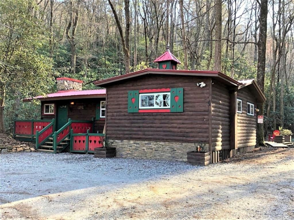 a small wooden cabin in the middle of a forest at Creekfront Cabin Amazing for Families in Helen, Georgia in Helen
