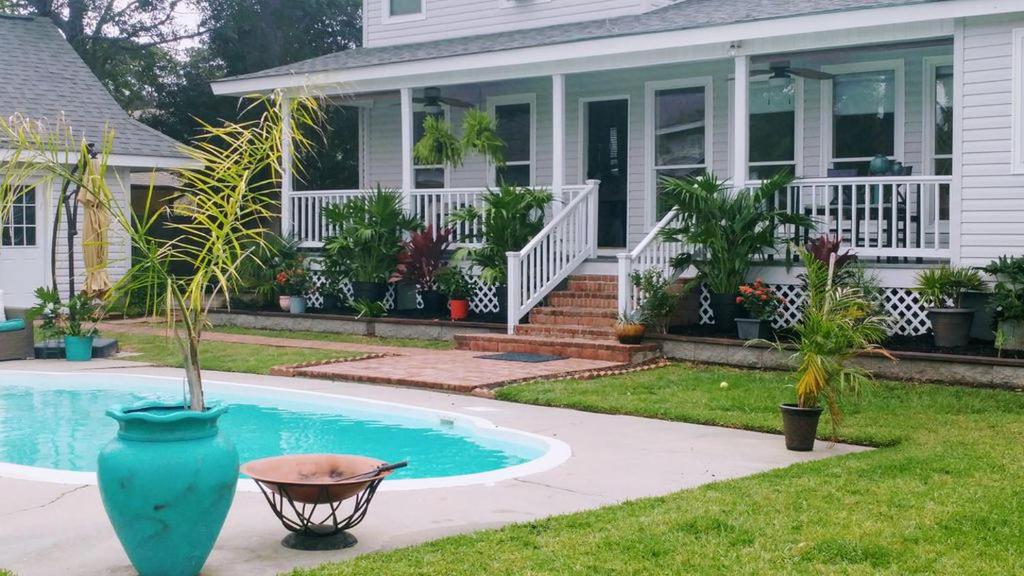 a house with a swimming pool in front of a house at Beautiful Waterfront Cottage Rental with a Pool near New Orleans, Louisiana in Slidell