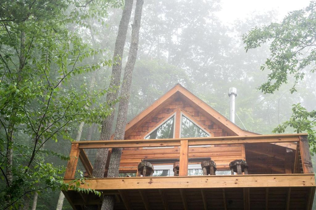 a tree house in the forest in the fog at Stunning Pet-Friendly Treehouse for Relaxing Glamping Retreats in North Carolina in Retreat