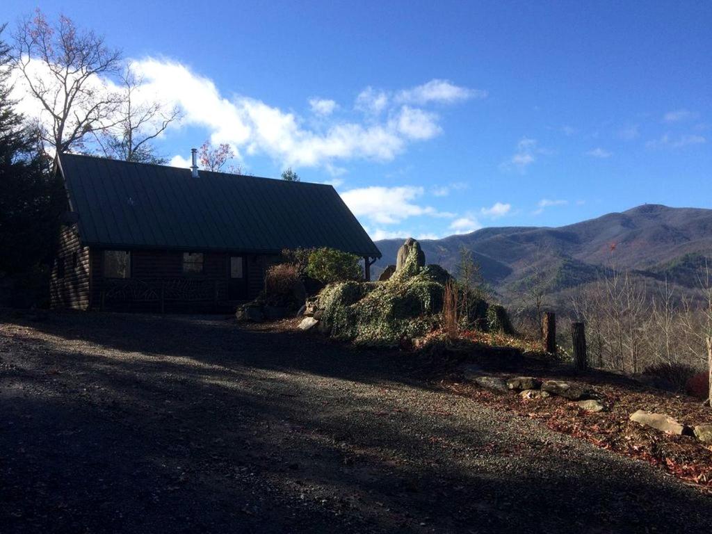 a house on the side of a road next to a mountain at Private Cabin with Wi-Fi Nestled in the Mountains of Hiawassee, Georgia in Mountain Scene