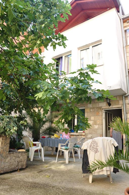 a group of chairs and a table in front of a house at Guest House Mirza in Mostar