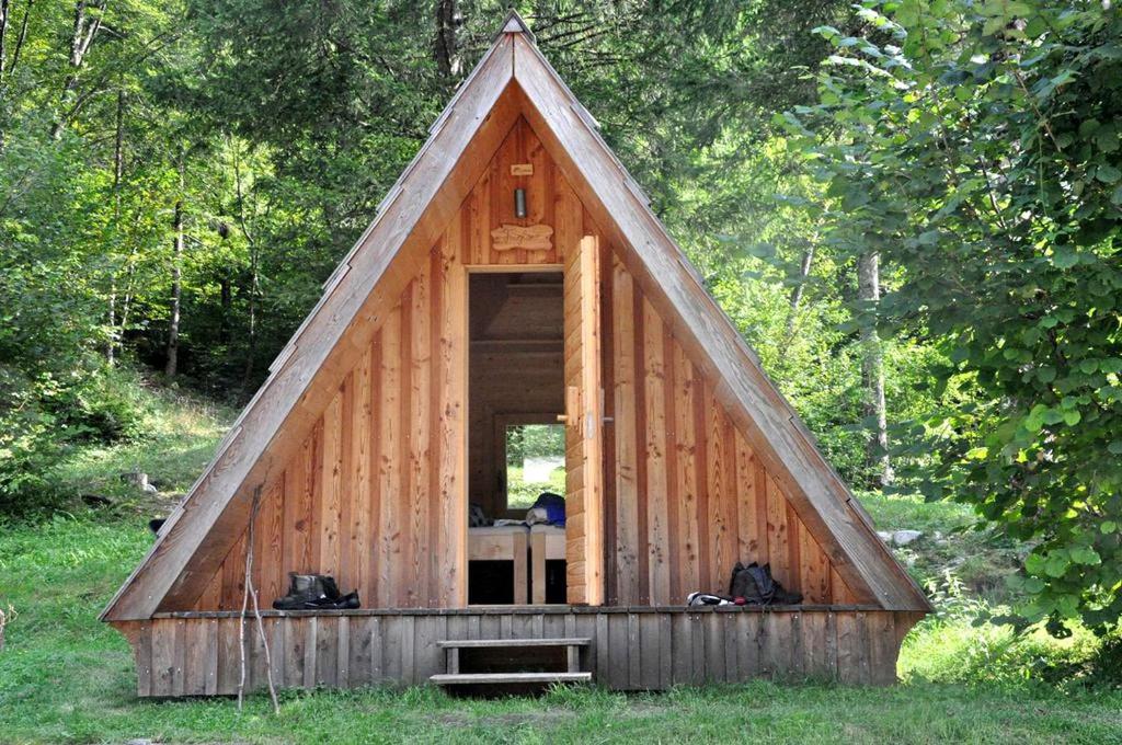 a large wooden cabin with a triangular roof at Unique A-Frame Cabin Rentals for a Vacation near Bovec, Slovenia in Soča