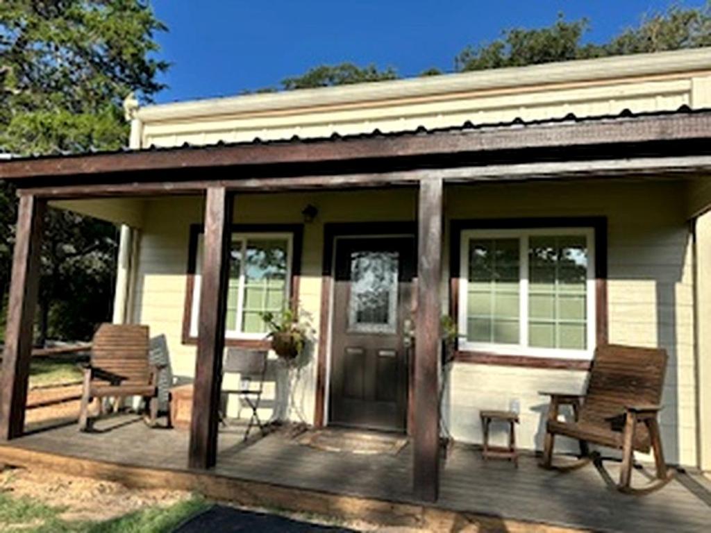 a screened in porch of a house with two chairs at Comfy Equipped Lodge Great for a Peaceful Getaway in Texas in Waelder