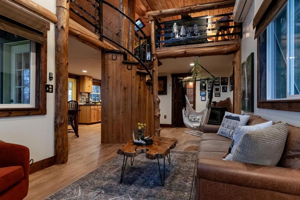 a living room with a couch and a table at Secluded Delight: Unplug and Reconnect in a Special House in Lake Toxaway's Woods in Indian Lake Estates