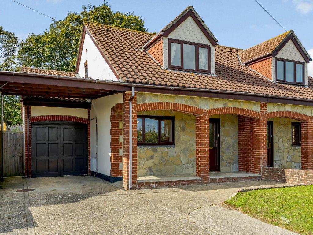 a brick house with a garage at 2 bed in Totland Bay IC003 in Freshwater