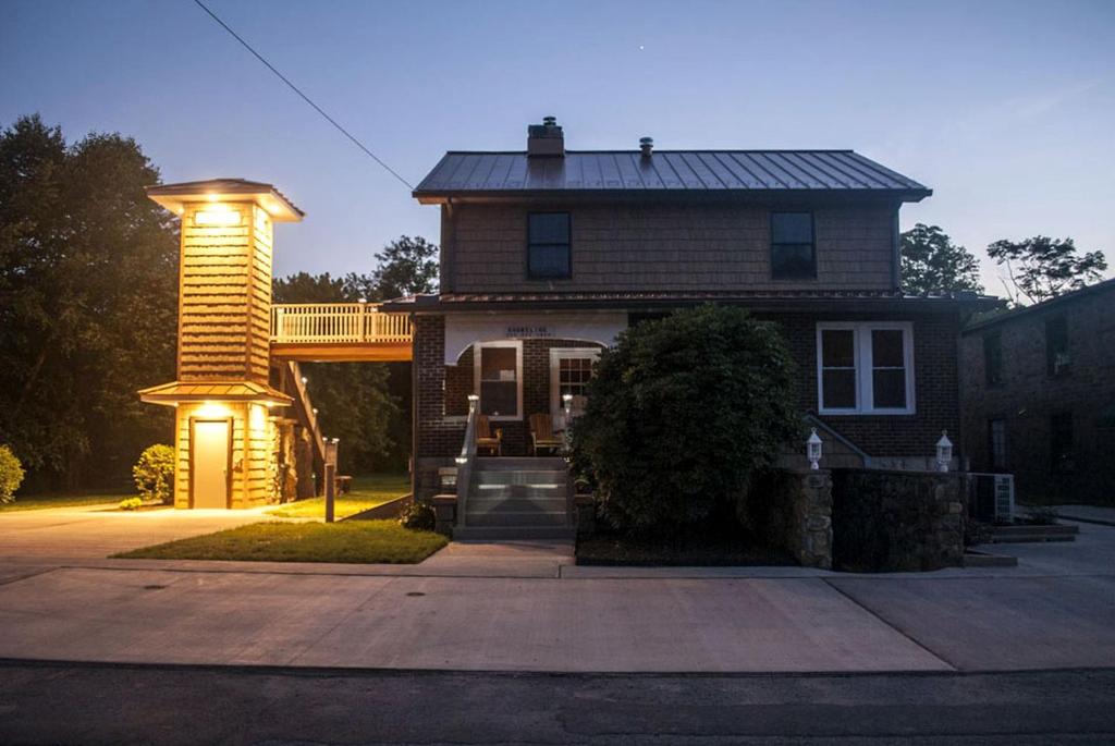 a house with lights on the front of it at Waterfront Vacation Rental for Two Guests near Ohiopyle State Park, Pennsylvania in Confluence
