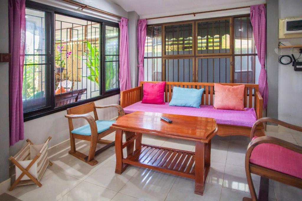 a living room with a couch and a table at House 4 people sea view 100 m from the beach in Klong Muang Beach