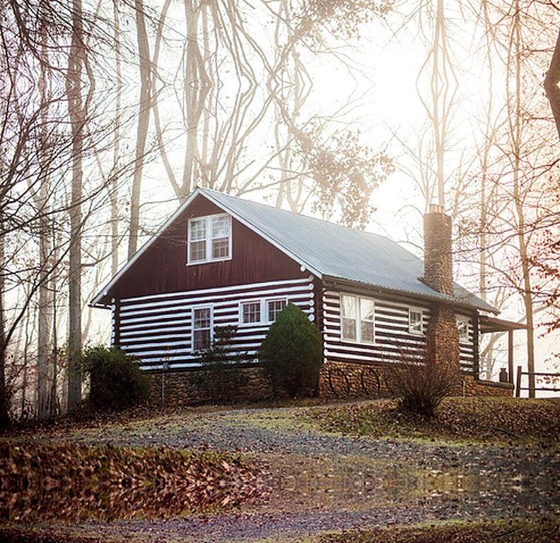 a red and white house in the woods at Charming Glamping Rental with Fireplace near Great Smoky Mountains National Park in Greeneville