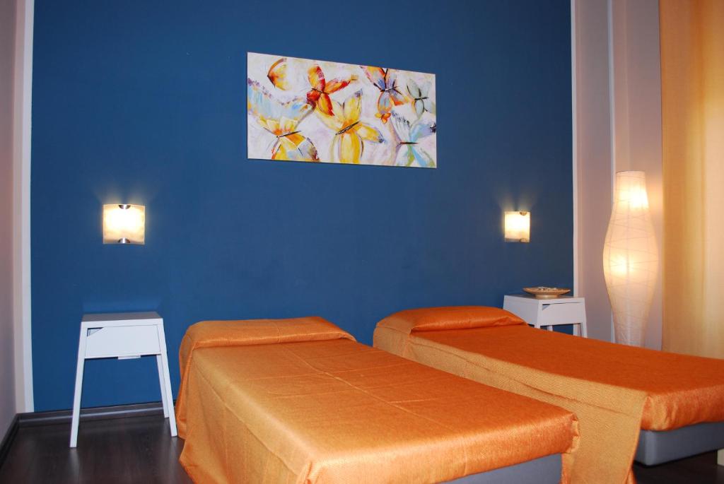 pokój z dwoma łóżkami i obrazem na ścianie w obiekcie Un Letto a Casteddu w Cagliari