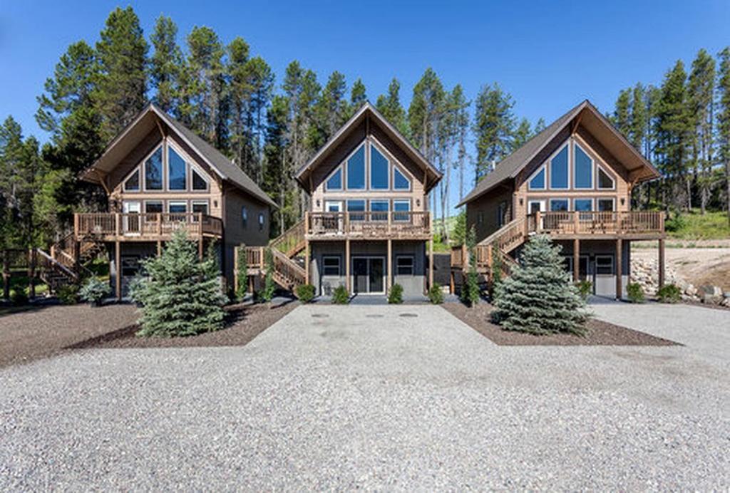 a large house with trees in front of it at Charming Mountain Cabin for a Family Getaway near Lake McDonald, Montana in West Glacier