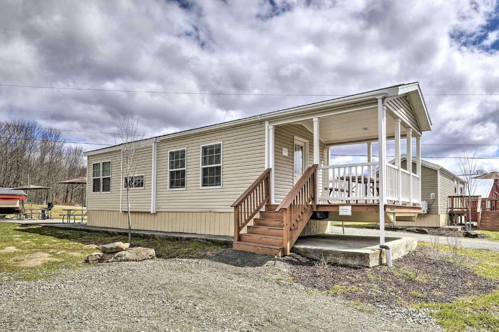 a small house with a porch and stairs on it at Great Vacation Complex for the Best Pennsylvania Glamping in Poyntelle