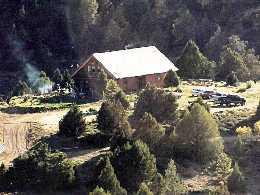an aerial view of a house in a forest at Spacious, Inviting Log Cabin Encircled by Wildlife in Utah in Long Valley Junction