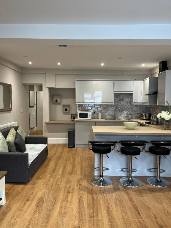 a kitchen and living room with a couch and a counter at Flat in Maerdy in Maerdy