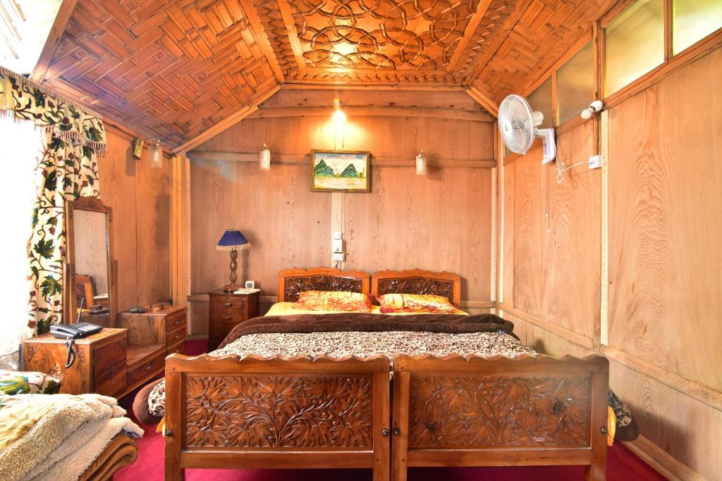 a bedroom with a bed with a wooden ceiling at HZP Yacht in Srinagar