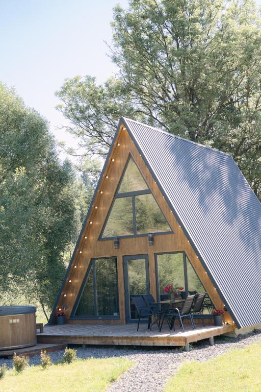 a frame house with glass windows and a pitched roof at Riverview cottage in Pilipets