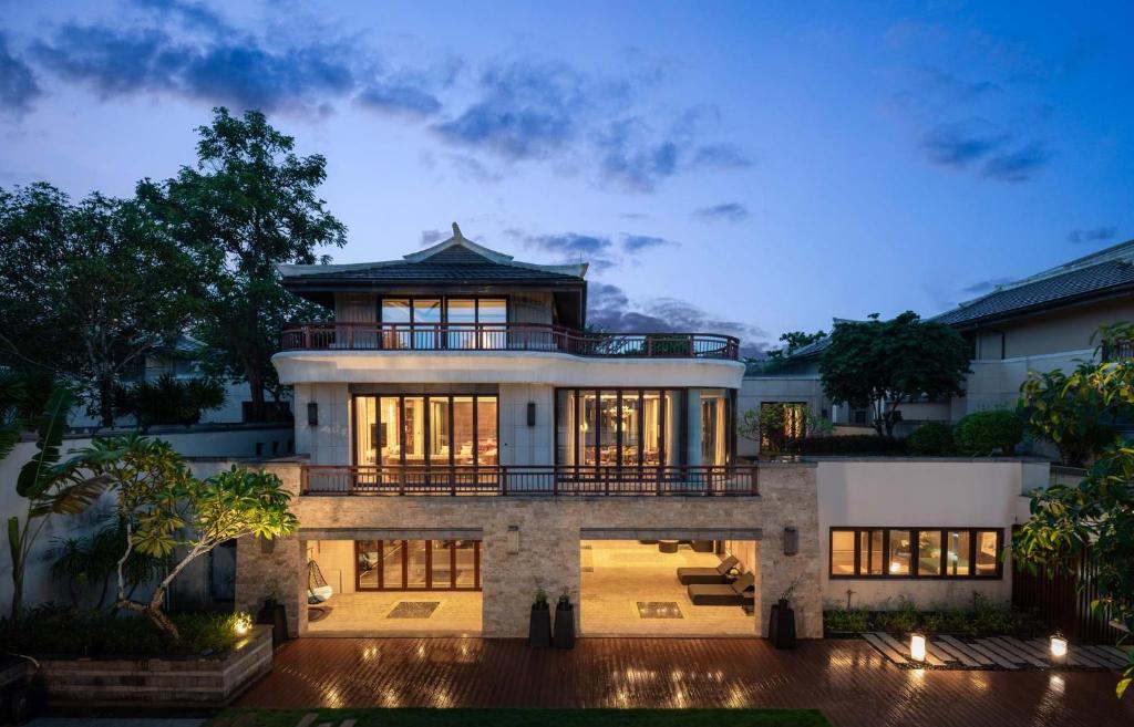 a large house with a balcony on top of it at Sanya Haitang Bay Renguan Sea View Pool Villa (Water World Duty Free City Store) in Sanya