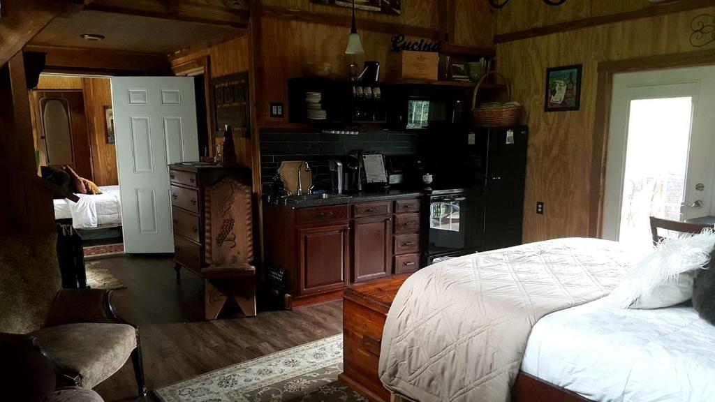 a bedroom with a bed and a kitchen in it at Lovely Weekend Getaway Rental near Edgar Evins State Park in Tennessee in Gordonsville