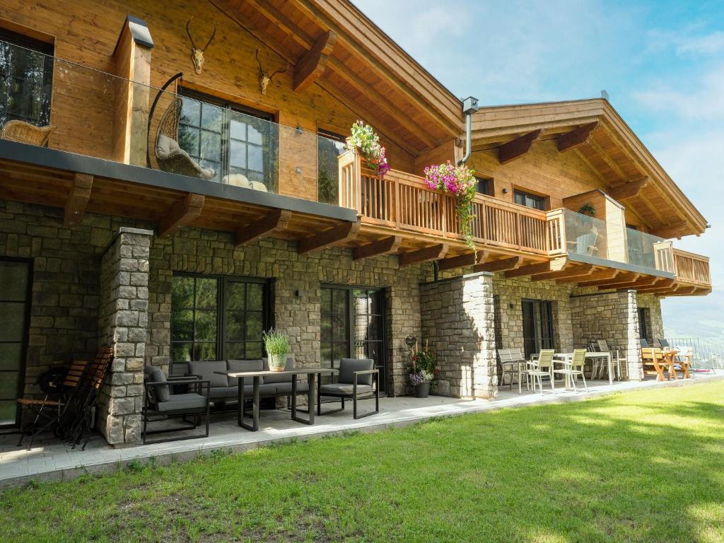 a house with a deck and a patio at Chalet in Krimml near Zillertal Ski Arena in Krimml