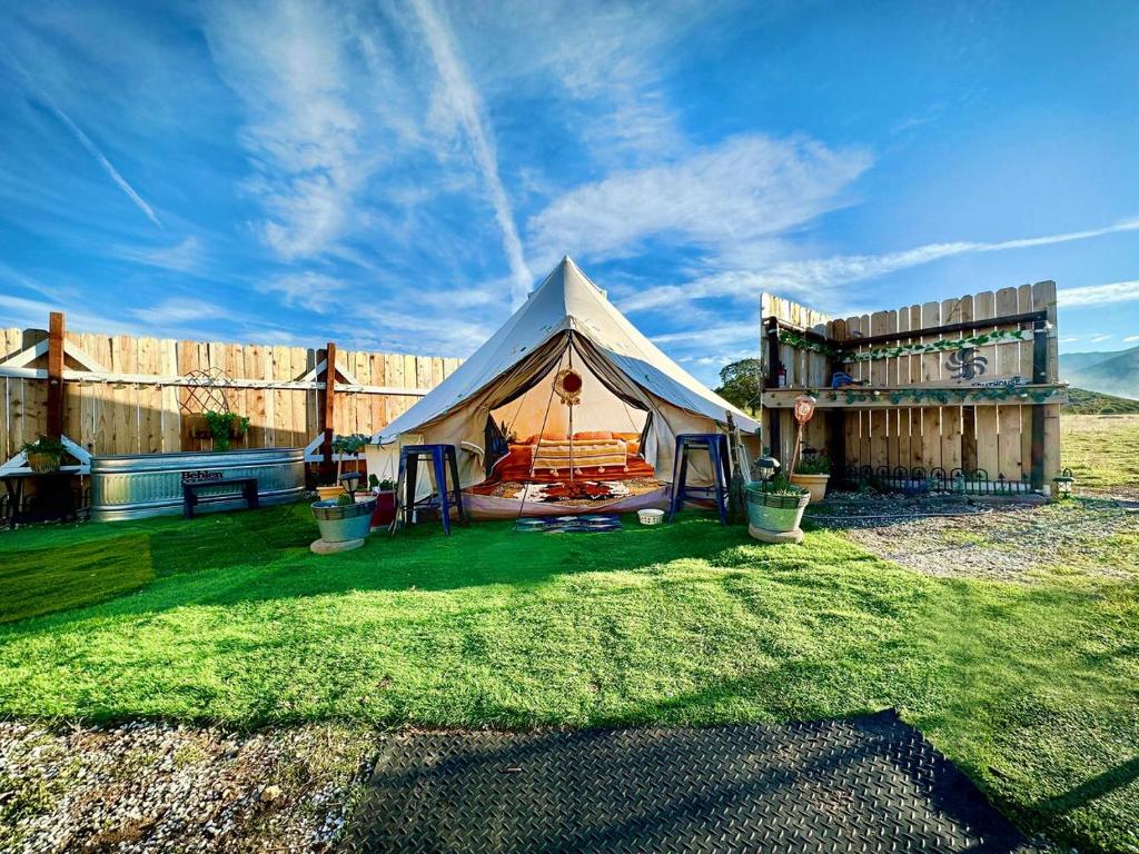 a large tent in a yard with a fence at The Pink Pony Yurt, New Cuyama, CA in New Cuyama