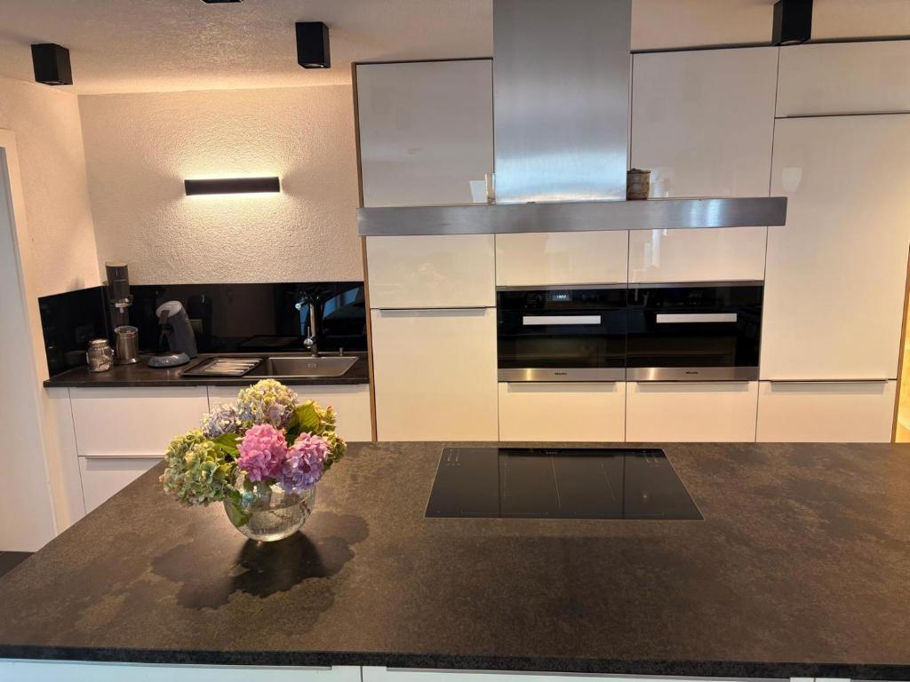 a kitchen with a vase of flowers on a table at Bei die Gstrein's in See