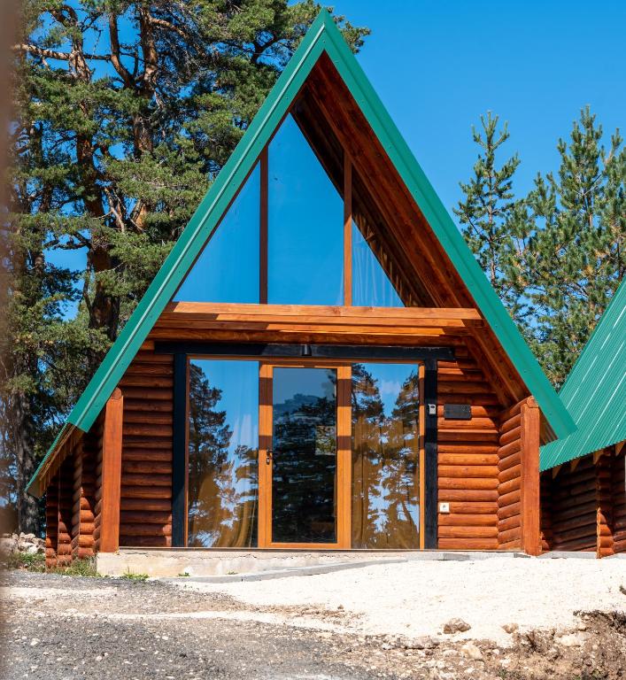 a log cabin with large glass windows at Wood heaven in Žabljak