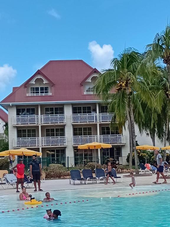 a group of people in the swimming pool at a hotel at Studio Saint Vincent 13 Non PMR in Sainte-Luce