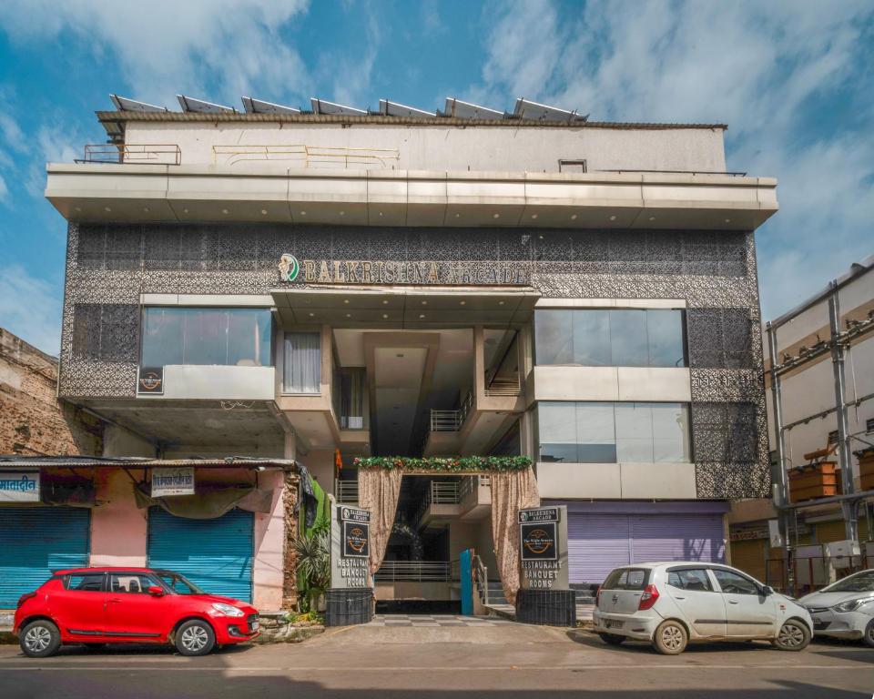 a building with cars parked in front of it at The White Seasons in Gwalior